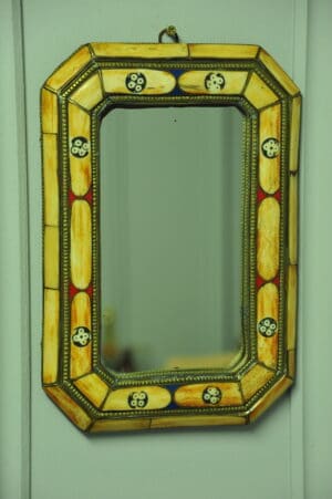 a vintage moroccan bone and brass decorated wall mirror