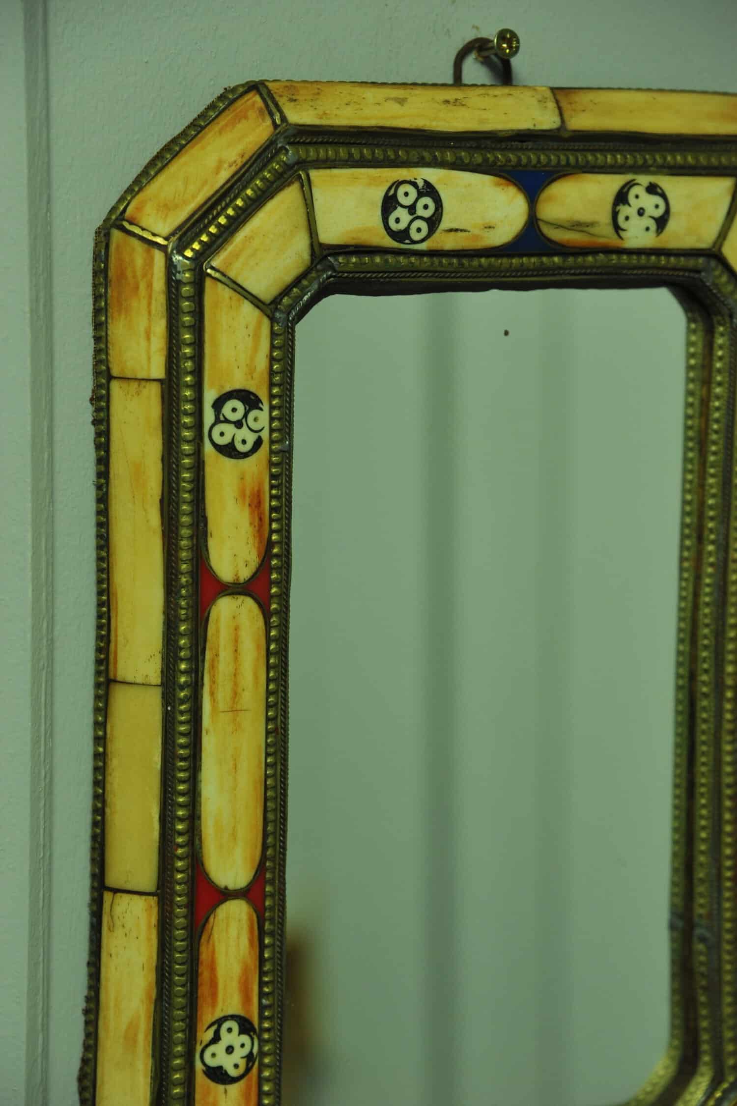 a vintage moroccan bone and brass decorated wall mirror