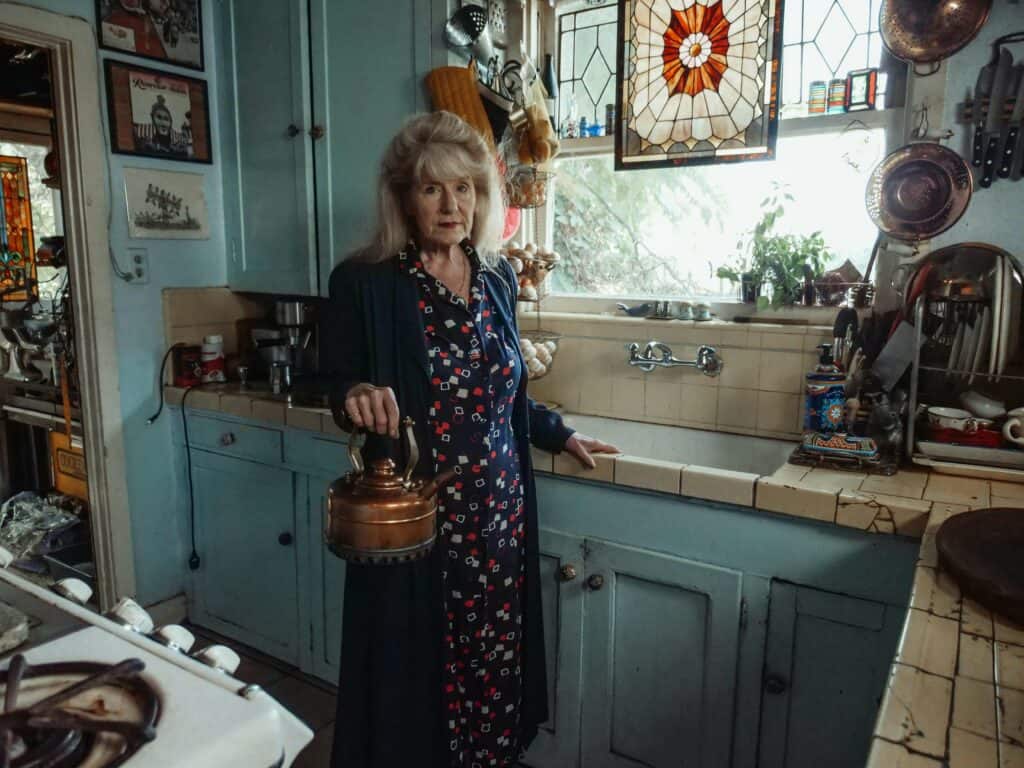 An image of a woman using Antique and Vintage Kitchenware at home.